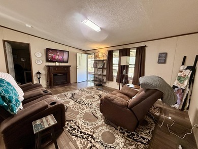 This charming home sits on 1 acre of unrestricted land, offering