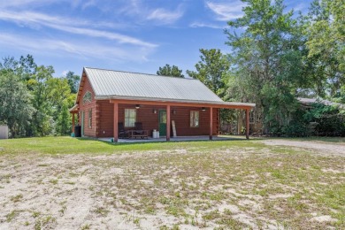 This stunning log cabin has been beautifully updated! - Lake Home For Sale in Florahome, Florida