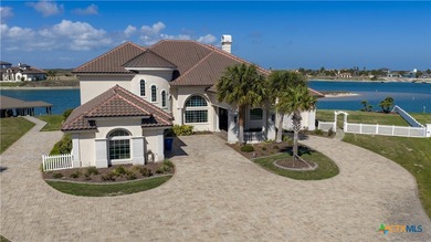 Located on the tranquil shores of the gated community of The - photo 1