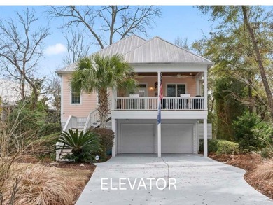 Four-bedroom, three-bathroom, elevated coastal home with a - photo 1