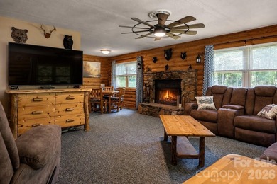 Escape to the mountains in this custom log cabin located in the - photo 3