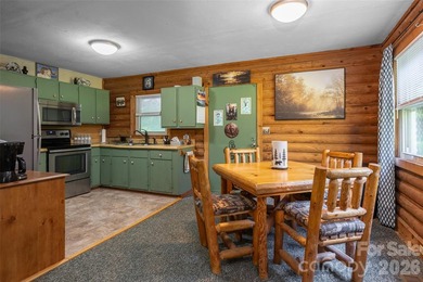 Escape to the mountains in this custom log cabin located in the - photo 5