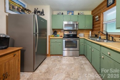 Escape to the mountains in this custom log cabin located in the - photo 6