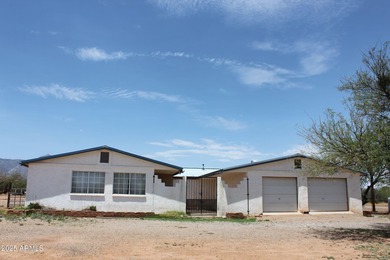 What a find...stucco 4BR/2BA home on 4 acres...covered front