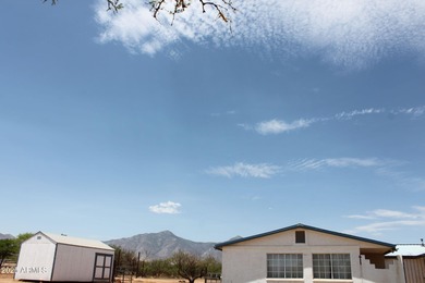 What a find...stucco 4BR/2BA home on 4 acres...covered front