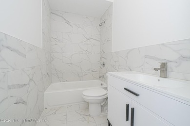 An exceptional new construction 6/6 two-family home offering 2 - photo 14