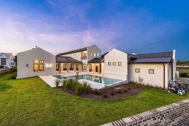 A showstopper of modern coastal elegance, 36 Sandcord Drive is a - photo 2