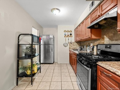 This three-story brick two-family home in Cypress Hills features - photo 6