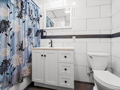 This three-story brick two-family home in Cypress Hills features - photo 7