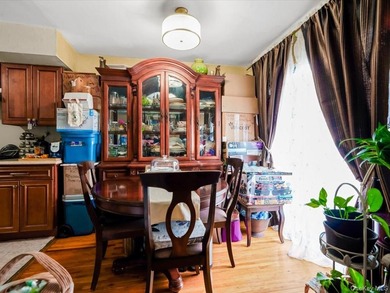 This three-story brick two-family home in Cypress Hills features - photo 8