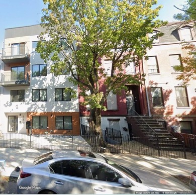 This four-story all-brick brownstone is full of potential and - photo 1