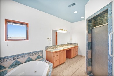 24 Hunter Drive is a pueblo style home in the Vista de Pedernal