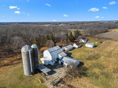 A homestead with 6 acres, several buildings that are set up for