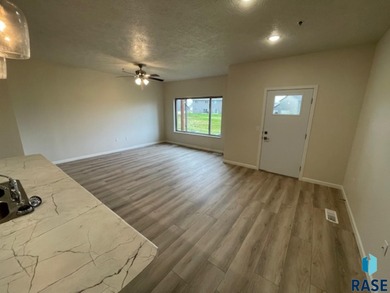 Open floor plan condo features large living room, spacious