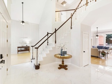Grand marble tile entry and soaring ceilings set the tone in - photo 2