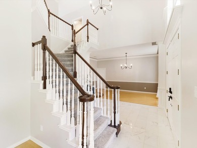 Grand marble tile entry and soaring ceilings set the tone in - photo 3