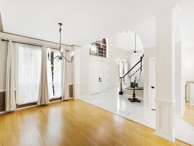 Grand marble tile entry and soaring ceilings set the tone in - photo 4