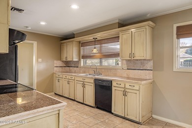 Underneath the branches of a mature live oak tree sits this