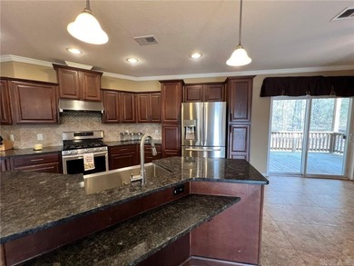 Well-maintained home on approximately 6 acres with a stocked