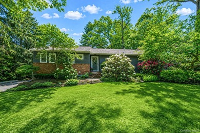 Nestled on a beautifully landscaped property surrounded by - photo 1