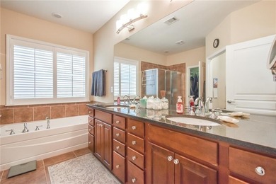 Welcome to this beautifully maintained four-bedroom, three-bath