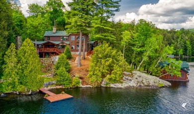 Kiwassa Lake Lodge sits above the shoreline in a way that - photo 2