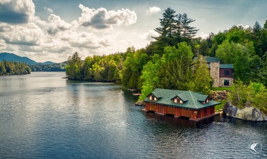 Kiwassa Lake Lodge sits above the shoreline in a way that - photo 3