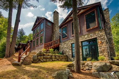 Kiwassa Lake Lodge sits above the shoreline in a way that - photo 7