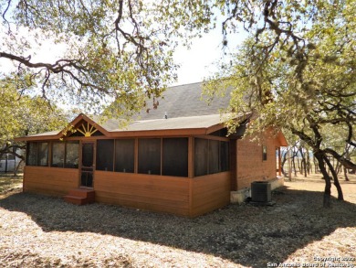 Adorable cedar cabin with 169 ft of gentle sloping waterfront - Lake Home For Sale in Lakehills, Texas