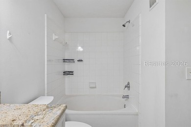 Enjoy wooded views from this second-floor condominium in The - photo 14
