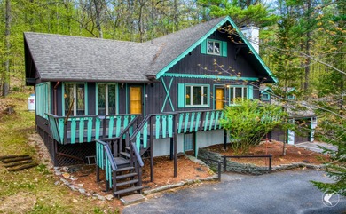 Nestled in a quiet wooded setting, this charming chalet-style - photo 1