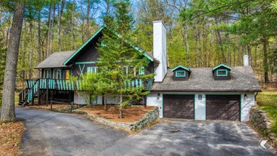 Nestled in a quiet wooded setting, this charming chalet-style - photo 2