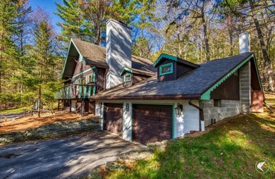 Nestled in a quiet wooded setting, this charming chalet-style - photo 3