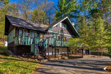 Nestled in a quiet wooded setting, this charming chalet-style - photo 4