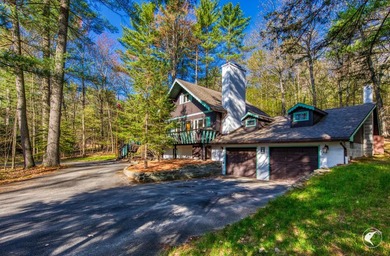 Nestled in a quiet wooded setting, this charming chalet-style - photo 5