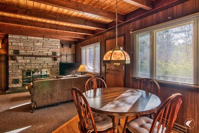 Nestled in a quiet wooded setting, this charming chalet-style - photo 9