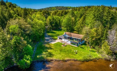 Set along the shoreline of Lower Saranac Lake within the - photo 3