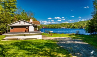 Set along the shoreline of Lower Saranac Lake within the - photo 4