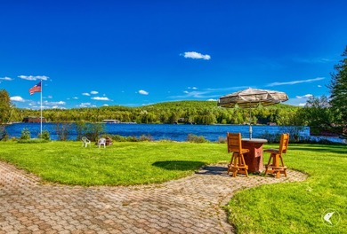 Set along the shoreline of Lower Saranac Lake within the - photo 6