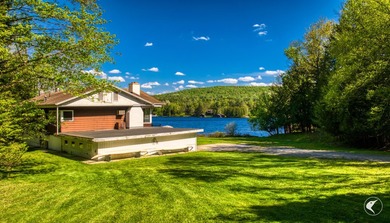Set along the shoreline of Lower Saranac Lake within the - photo 10