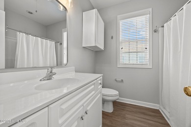 This meticulously maintained four-bedroom, three-bath waterfront