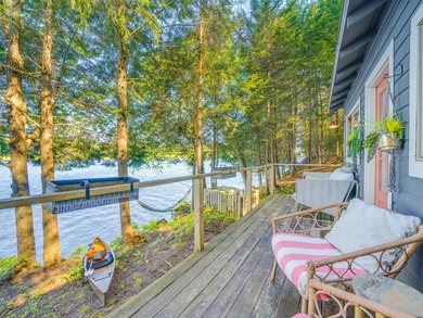 Set along approximately 150 feet of pristine shoreline on the - photo 6
