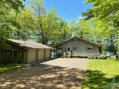 Looking for a beautiful lakefront setting? The park like feel of - Lake Home For Sale in Hazelhurst, Wisconsin