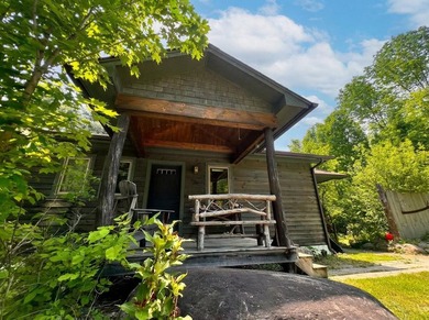 This 3-bedroom, 2-full-bath home in Wilmington, NY sits on a - photo 1