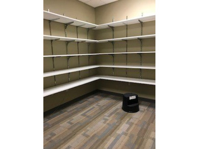 The first floor has a vestibule entrance with a stairwell and