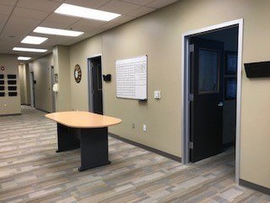 The first floor has a vestibule entrance with a stairwell and