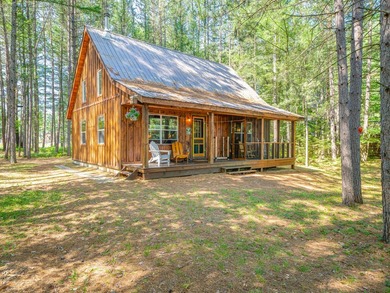 South of the bridge on Long Lake, this waterfront camp sits in a - photo 1
