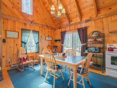 South of the bridge on Long Lake, this waterfront camp sits in a - photo 9