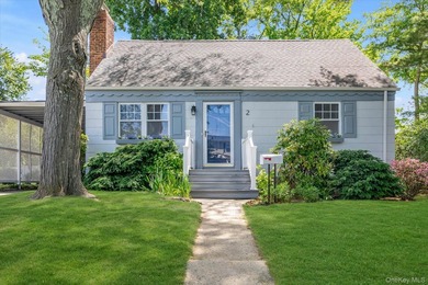 Welcome to this charming expanded 4-bedroom, 2-bath Cape nestled - photo 1