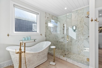 This gorgeous home in Kure Beach Village has 5 bedrooms, 5 1/2